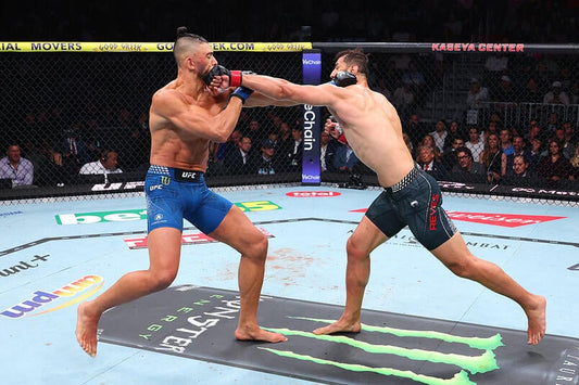 Dominick Reyes landing a punch on Johnny Walker at UFC 327 in April 2026