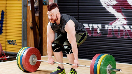 Sheamus performing a loaded deadlift in a gym, demonstrating his strength-training foundation