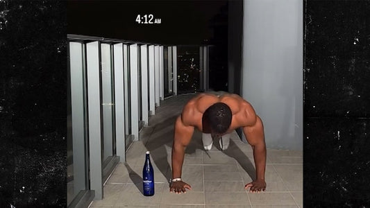 Ashton Hall performing early-morning push-ups on a balcony