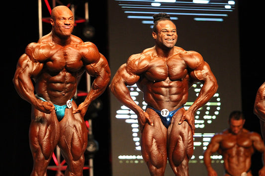 Phil Heath and Kai Greene posing side by side at the 2012 Mr. Olympia