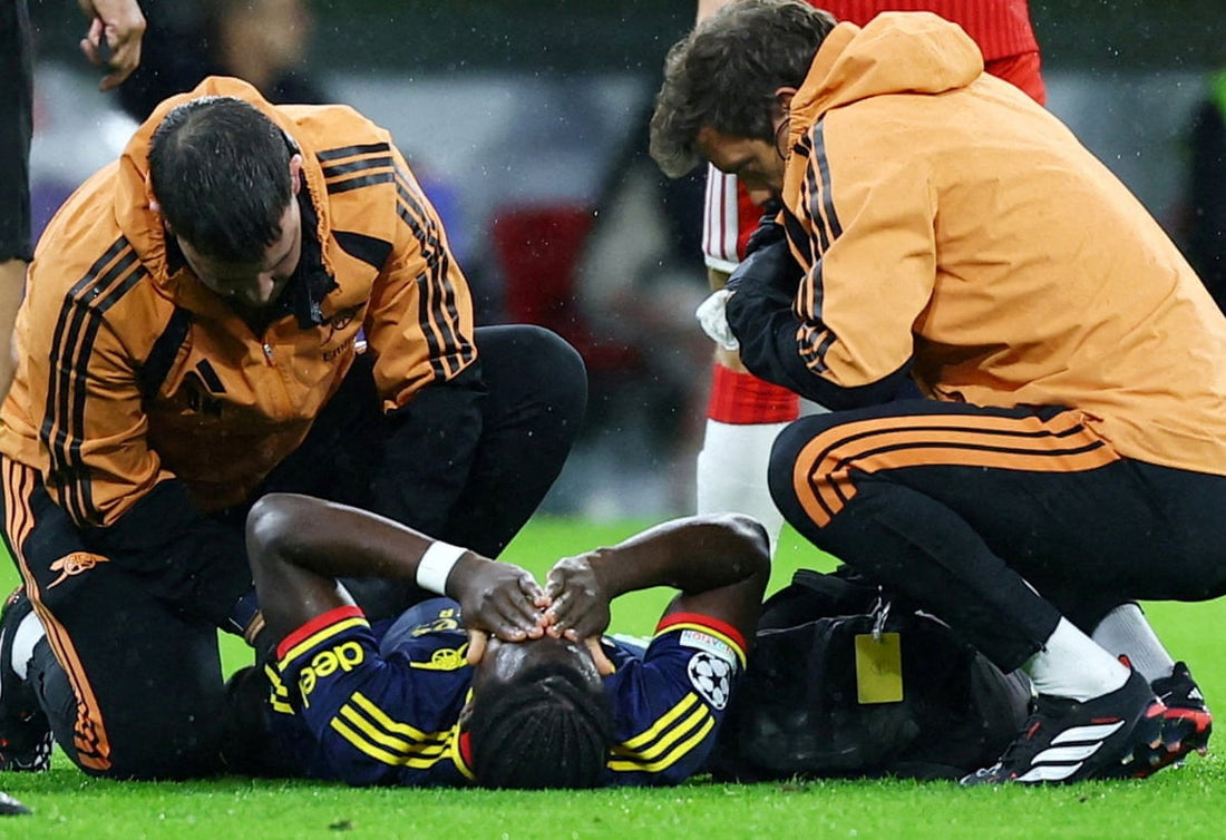 Bukayo Saka receives medical attention during Arsenal's October 2026 match at Bayern Munich