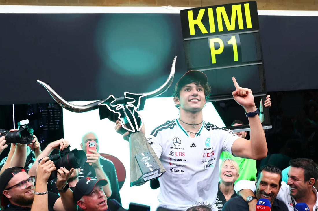Kimi Antonelli celebrates his October 2026 United States Grand Prix victory with the Mercedes team and a KIMI P1 sign