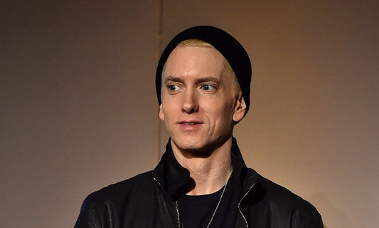 Eminem in a black beanie and leather jacket in a close-up portrait