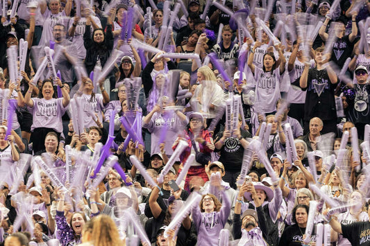 Golden State Valkyries fans in purple wave thundersticks at Chase Center during the 2026 playoffs