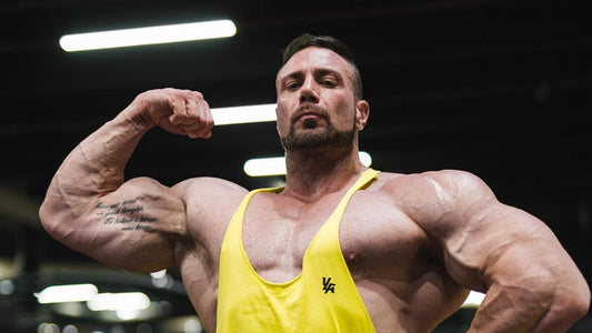 Noel Deyzel training with weights at a gym, illustrating controlled heavy lifting