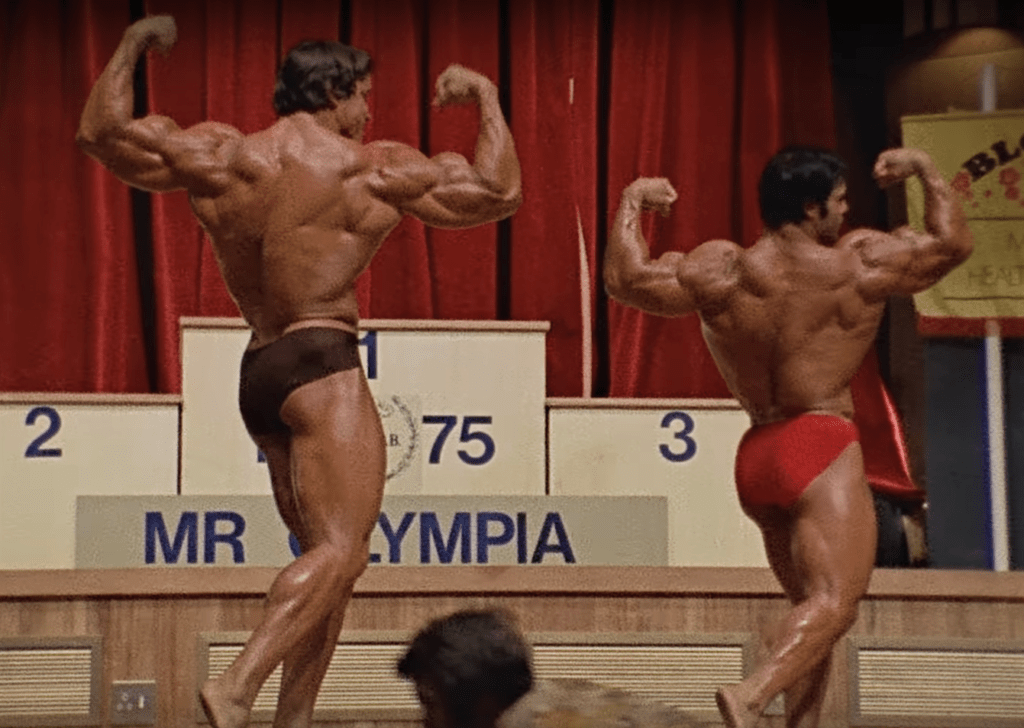 Lou Ferrigno and Arnold Schwarzenegger posing at the 1975 Mr. Olympia