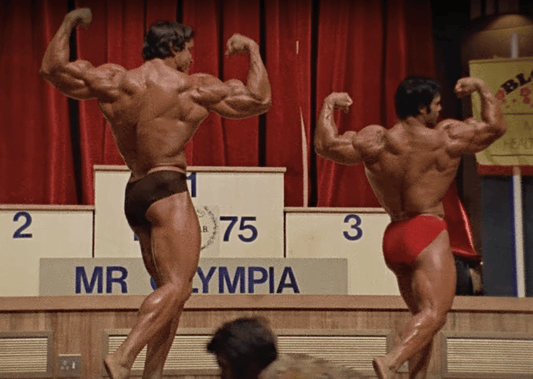 Lou Ferrigno and Arnold Schwarzenegger posing at the 1975 Mr. Olympia