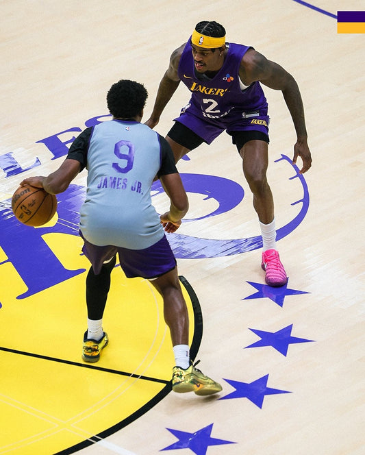 Bronny James working with a basketball in Lakers gear