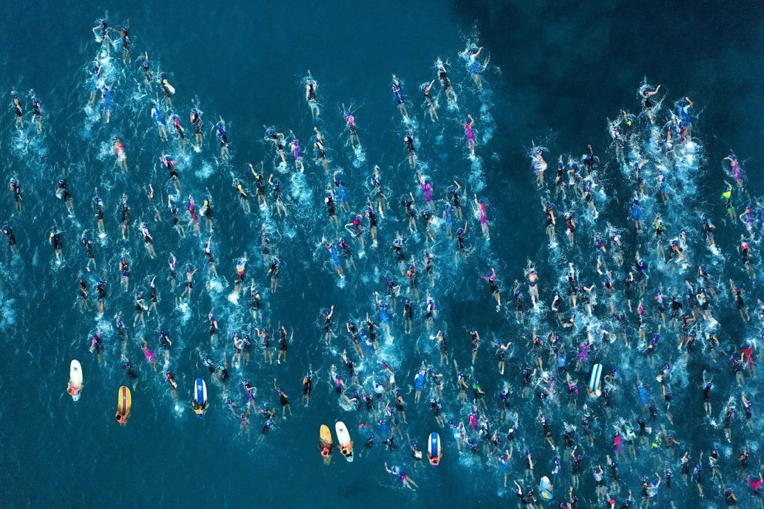 Aerial view of Ironman swimmers crossing Kailua Bay in Kona