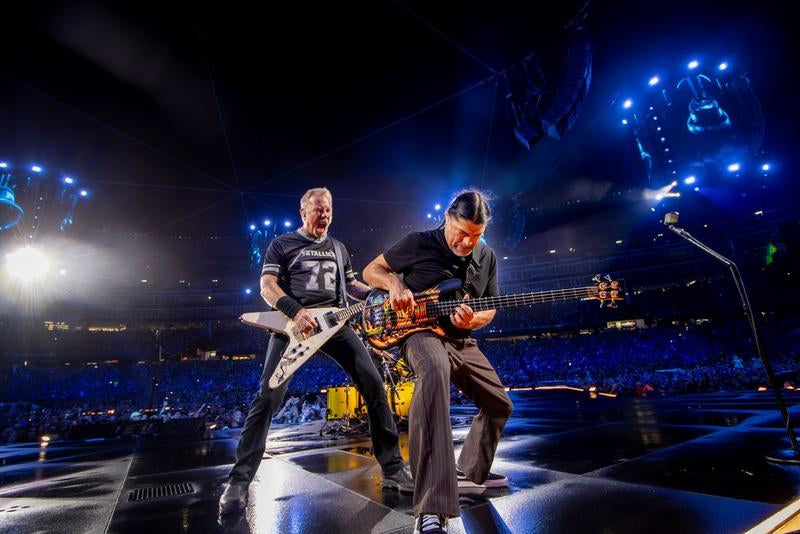 James Hetfield and Robert Trujillo performing on a stadium stage during Metallica's M72 World Tour