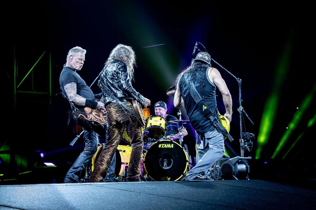 Metallica performing live onstage under heavy-metal concert lighting