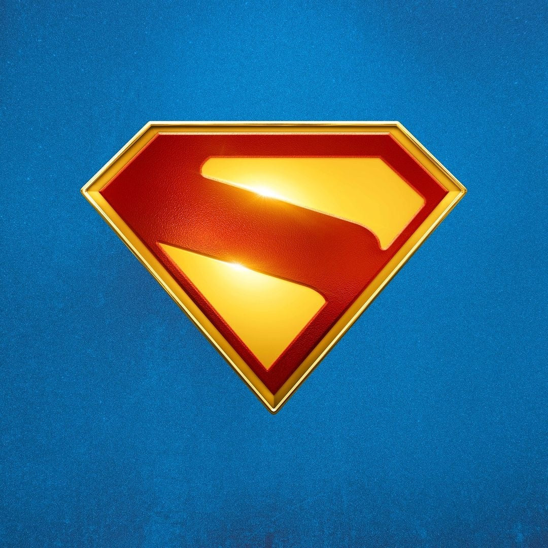 Red-and-yellow Superman S-shield emblem centered on a textured blue background