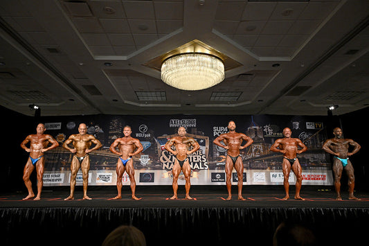 Archival photograph of male masters bodybuilders posing on a competition stage; illustrative, not 2026 Hurricane Pro