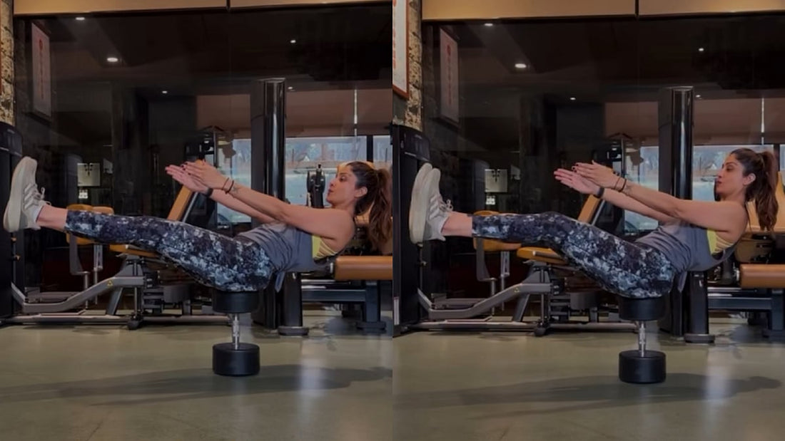 Malaika Arora demonstrating a controlled side-bend stretch in a gym studio
