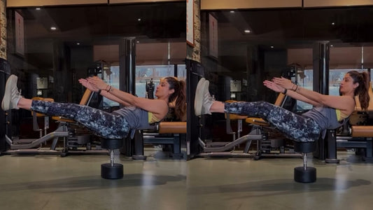Malaika Arora demonstrating a controlled side-bend stretch in a gym studio