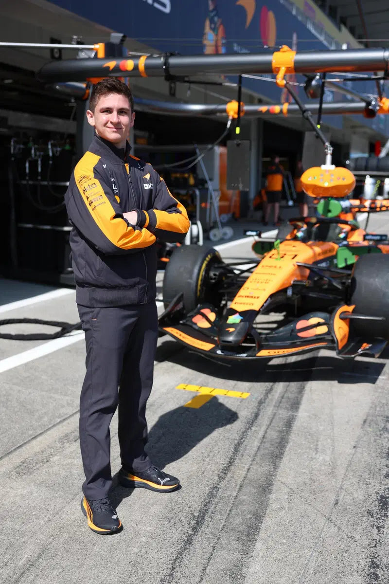 Leonardo Fornaroli beside a McLaren F1 car during the 2026 season