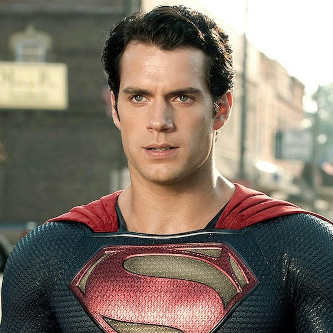 Henry Cavill as Superman in his blue suit with red cape and prominent chest shield