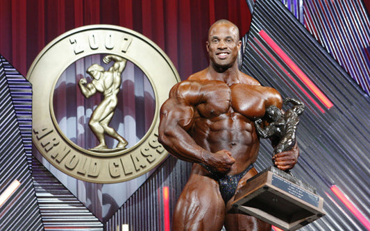Victor Martinez posing with a bodybuilding trophy