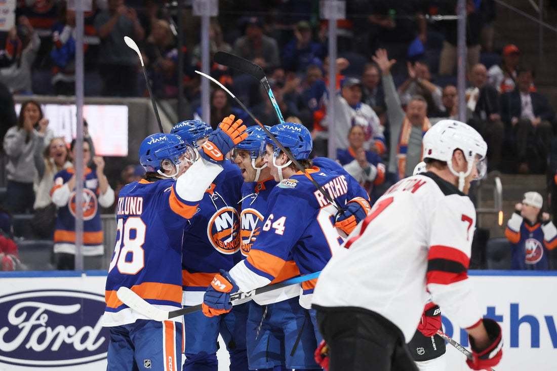 New York Islanders celebrate during their 6-0 home-opening win over the New Jersey Devils