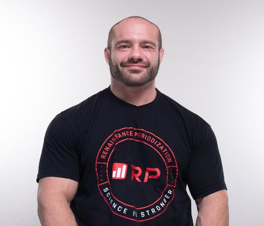 Mike Israetel speaking about training science in a black Renaissance Periodization tank top