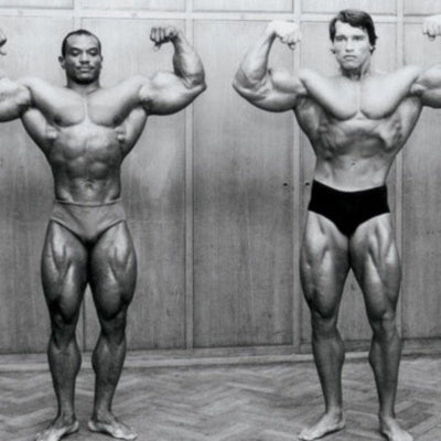 Arnold Schwarzenegger and Sergio Oliva posing side by side during their Golden Era rivalry