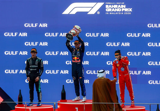 Max Verstappen lifts the winner's trophy at Sepang after Red Bull Ford's first Formula 1 power-unit victory.