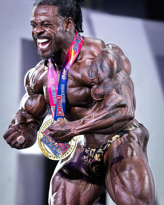 William Bonac posing after a bodybuilding victory