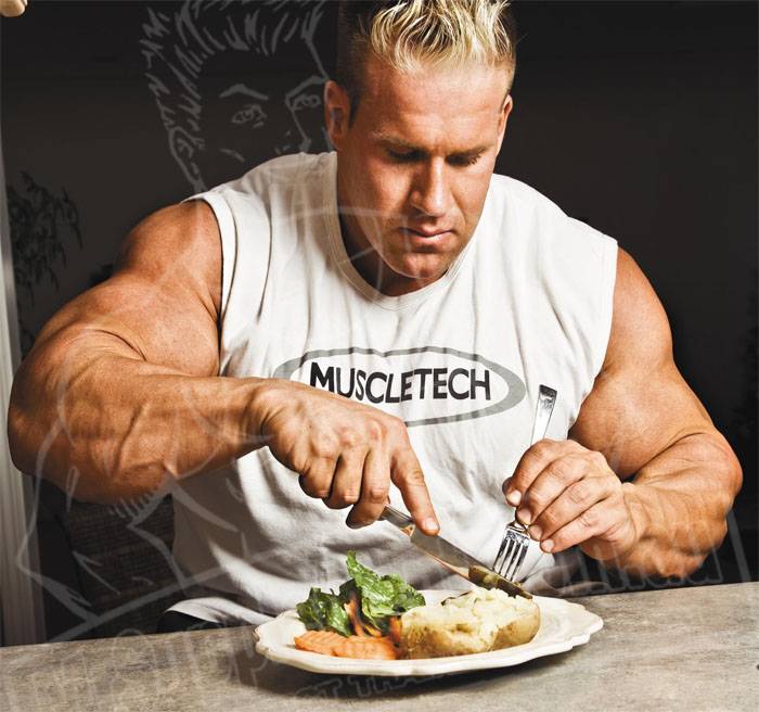 Jay Cutler eating a plate of protein, vegetables and potatoes at a table