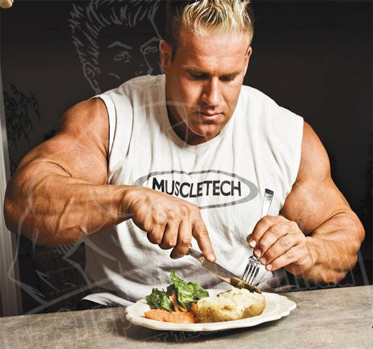 Jay Cutler eating a plate of protein, vegetables and potatoes at a table