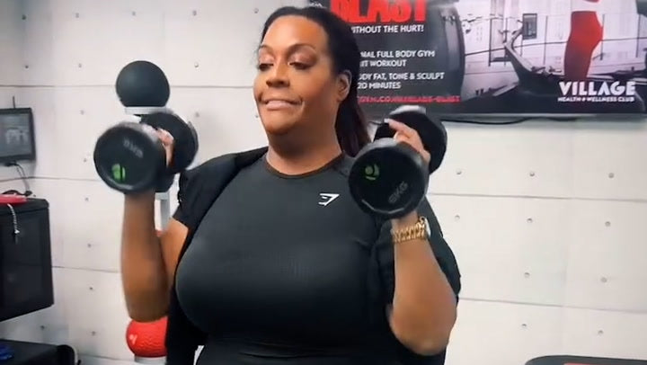 Alison Hammond exercising with a dumbbell in a gym