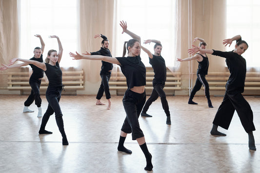 Contemporary dancers rehearsing together in a bright studio