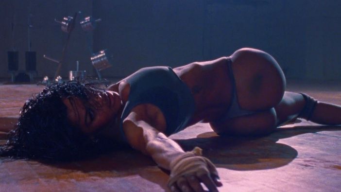 Teyana Taylor performing athletic choreography on the gym floor in Kanye West's Fade video