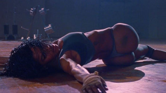 Teyana Taylor performing athletic choreography on the gym floor in Kanye West's Fade video