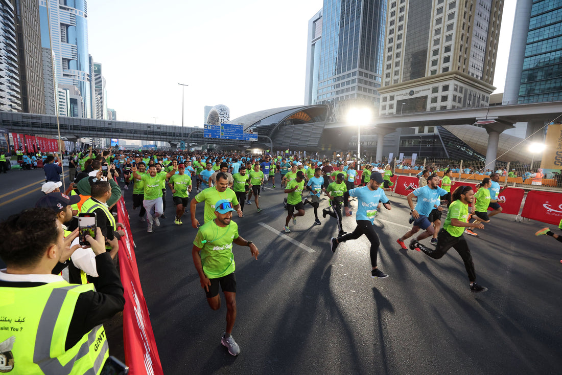 Runners in green and blue shirts filling Sheikh Zayed Road during Dubai Run