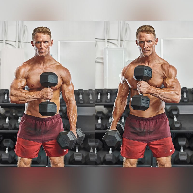An athlete performing strict standing dumbbell hammer curls with palms facing inward in a real strength gym