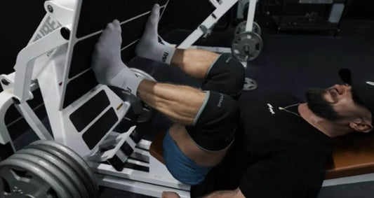 Chris Bumstead training legs in a bodybuilding gym