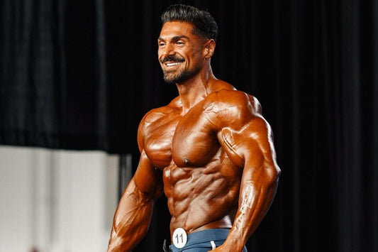 Andrei Deiu presenting a highly conditioned Men's Physique stage look at the 2026 Olympia