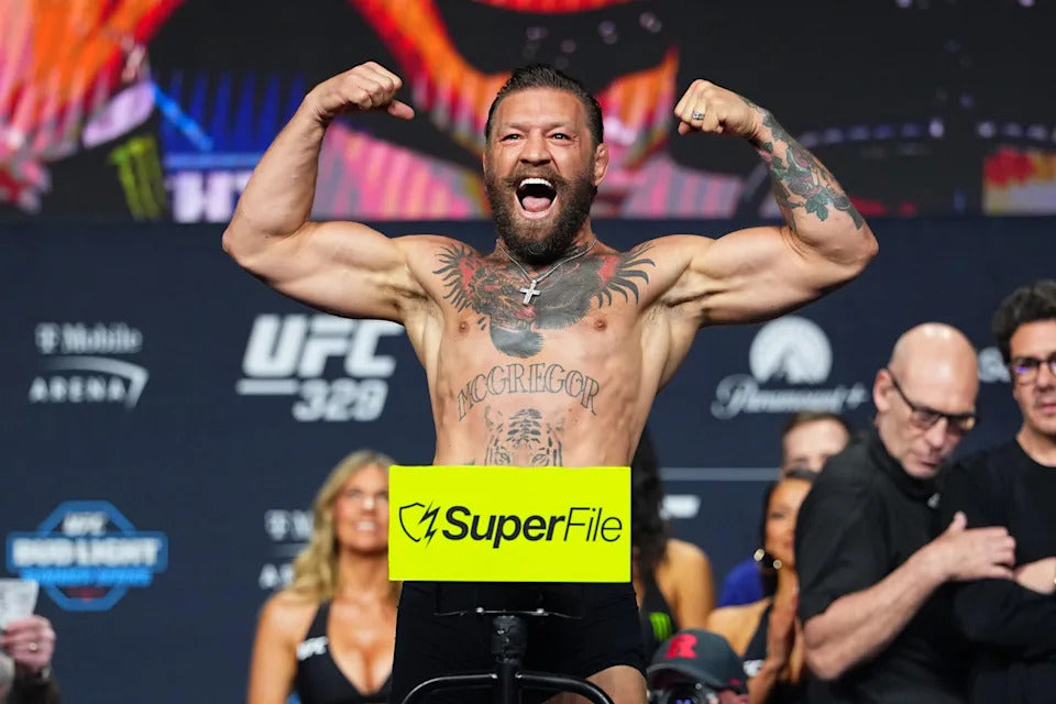 Conor McGregor flexes during the July 2026 UFC 329 weigh-in in Las Vegas