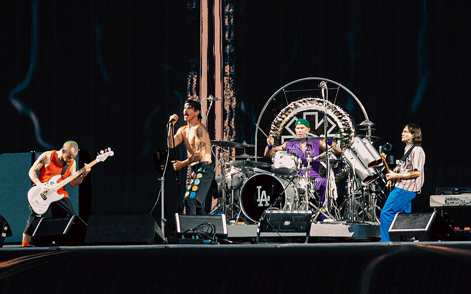 Red Hot Chili Peppers performing together onstage with Anthony Kiedis, Flea, Chad Smith and John Frusciante