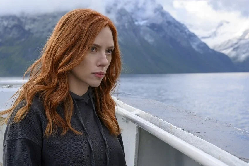 Natasha Romanoff in a black hoodie with a restrained spy-style look