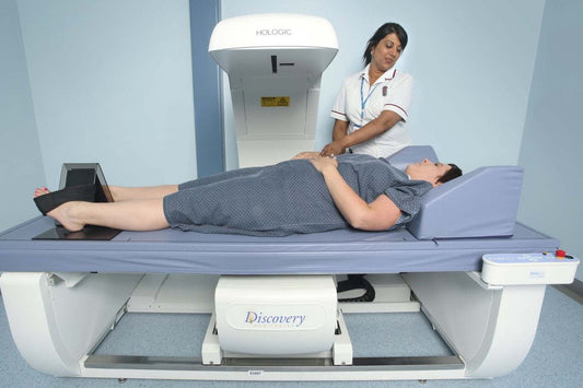 A clinician preparing a patient for a DXA body-composition scan