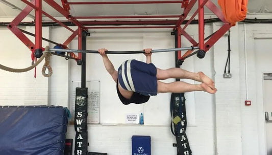 Calisthenics athlete performing a strict hanging windshield wiper with legs extended sideways from a pull-up bar