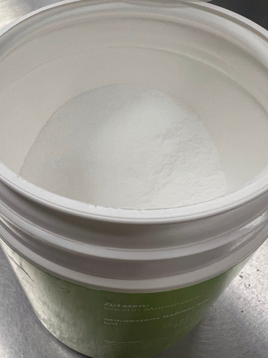Creatine monohydrate powder representing new research on creatine, lean mass and strength