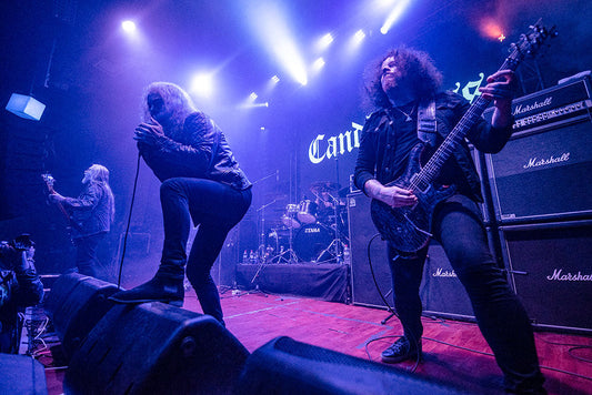 Candlemass performing doom metal on a purple-lit stage with vocalist and guitarist