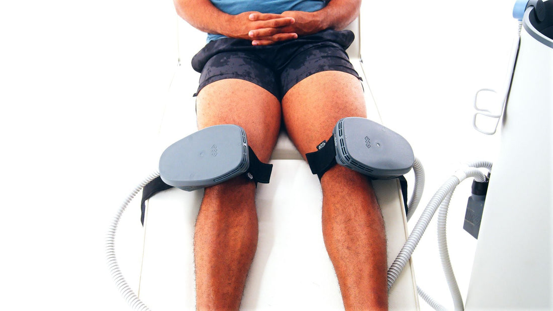 A man's thighs fitted with electromagnetic muscle stimulation applicators during a clinical Emsculpt Neo treatment