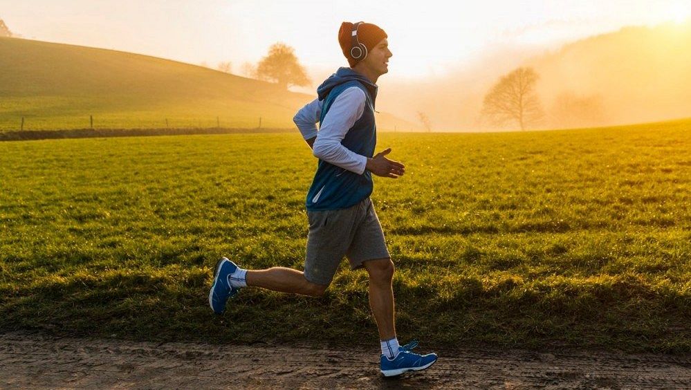 Runner wearing headphones on a steady outdoor long run
