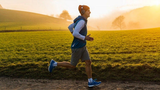 Runner wearing headphones on a steady outdoor long run
