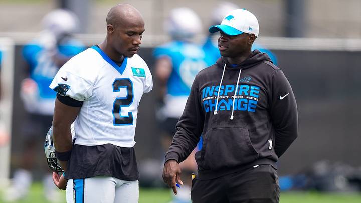 Carolina Panthers defensive coordinator Ejiro Evero speaking with cornerback Mike Jackson during 2026 minicamp