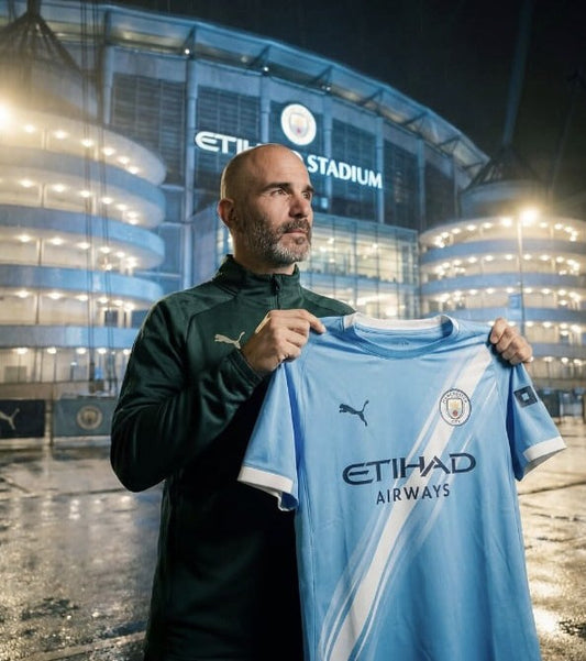 Enzo Maresca holding a Manchester City shirt outside the Etihad Stadium