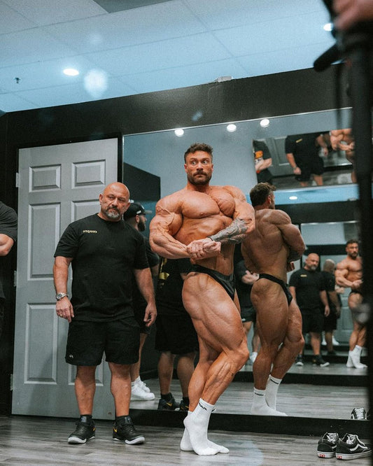 Chris Bumstead posing backstage in the final phase of his Olympia career